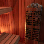 Modern indoor sauna with full glass front and warm lighting