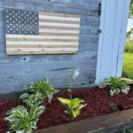 Natural unfinished wooden American flag for sauna decor and rustic cabin spaces