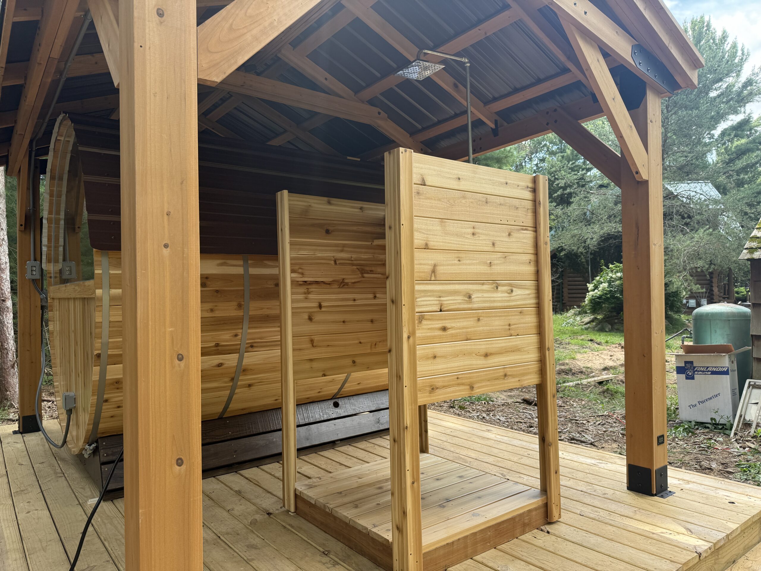 Close-up of the outdoor shower installed with the BMOC sauna setup