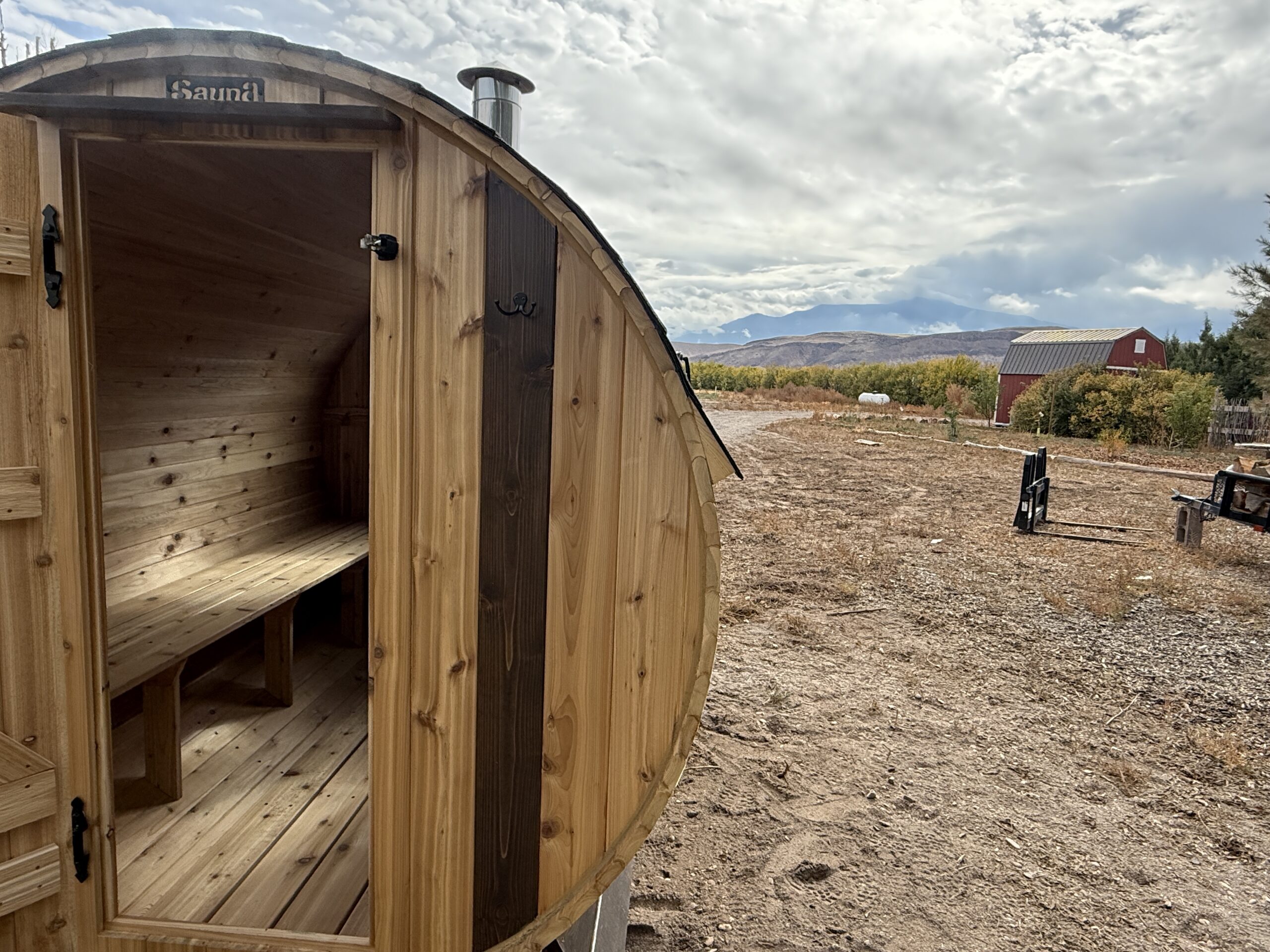 Front view of the Cedar Sense barrel sauna at Wildland Gardens in Utah