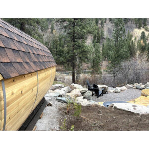 Side view of Kate's barrel sauna overlooking the scenic Blackfoot River in Montana